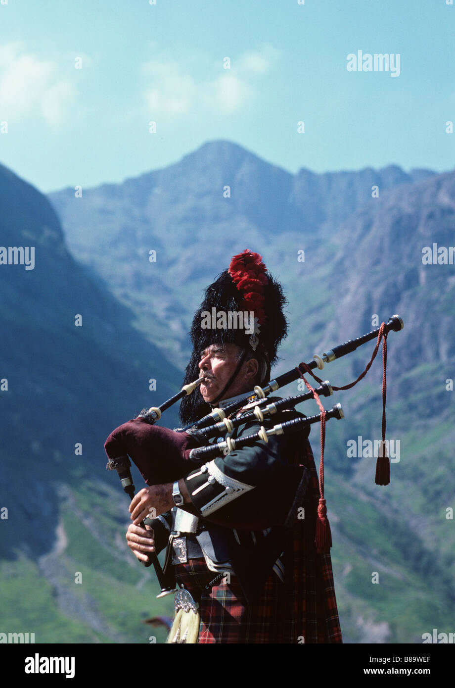 A Scotsman In Full Regalia Plays The Bagpipe In Glencoe Where The