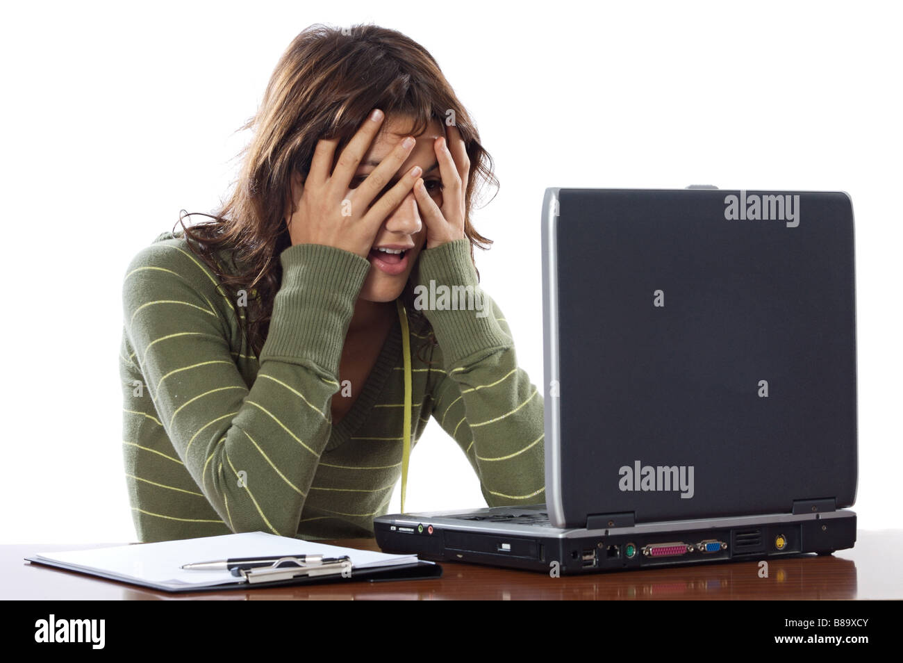 Beautiful frightened girl while looking at the laptop Stock Photo - Alamy