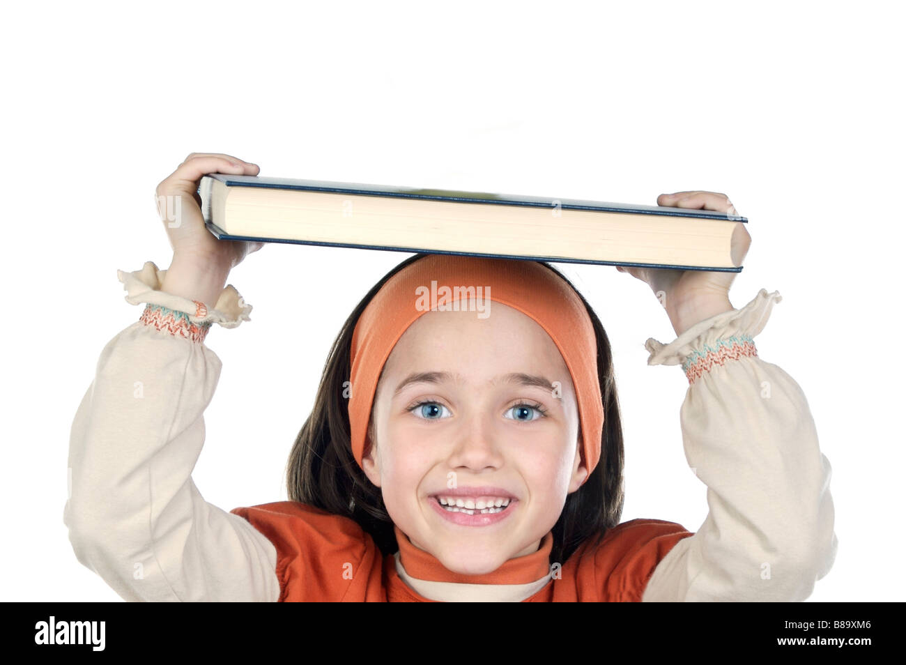 Cute young girl holding book on head Stock Photo - Alamy