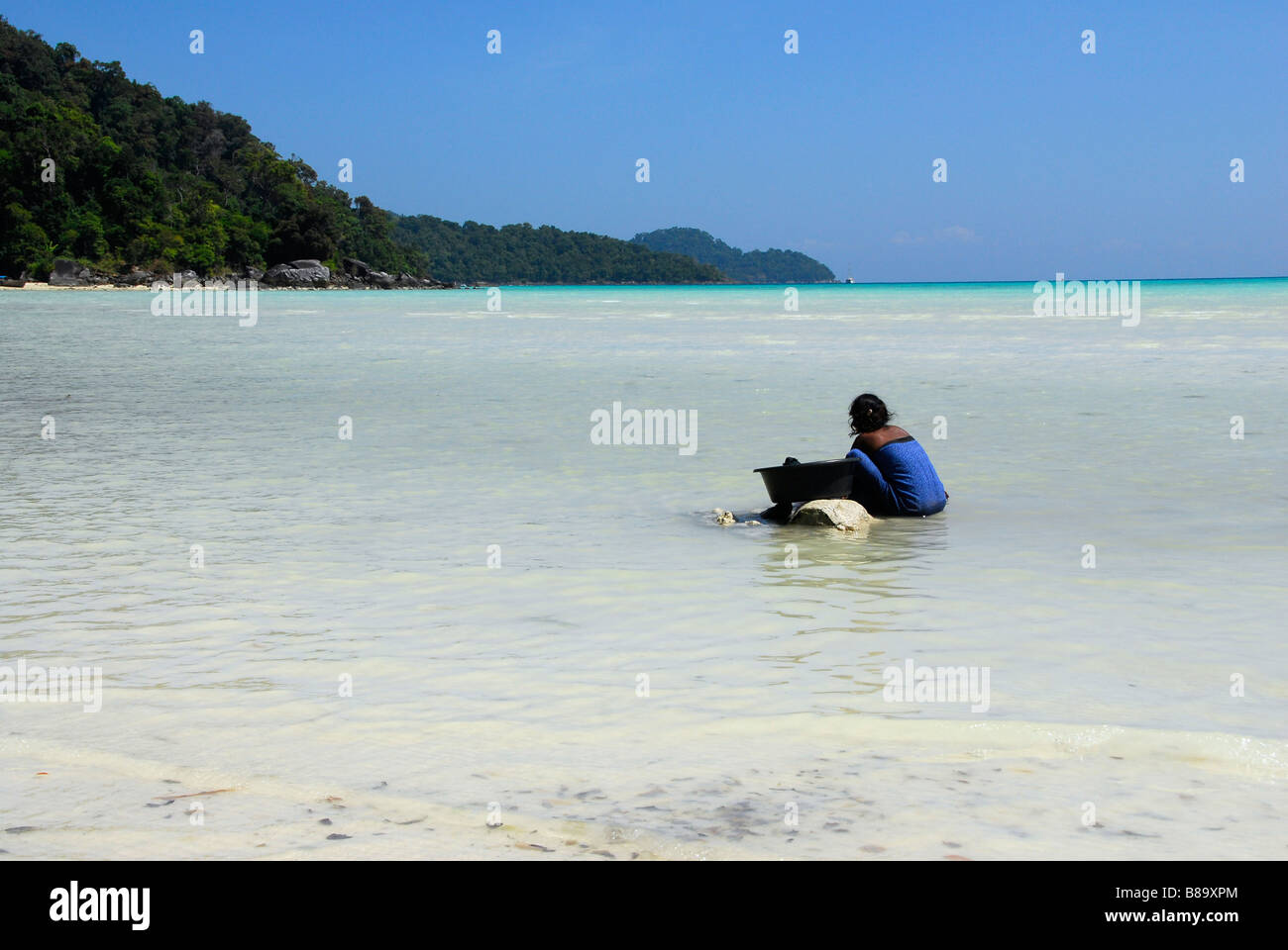 Moken sea gypsy woman washing clothes in the sea,Surin Island,PhangNga ...