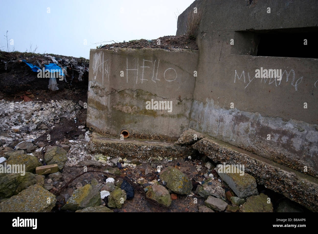 The word hello is chalked onto the side of a second world war bombshelter. Stock Photo