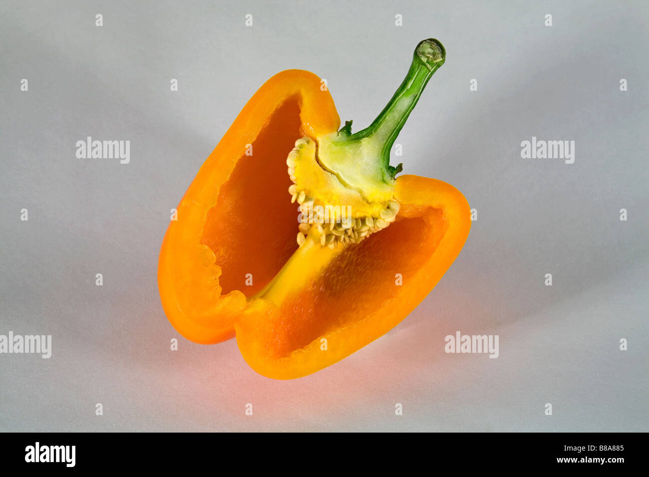 A yellow or orange bell pepper sliced or whole. Stock Photo
