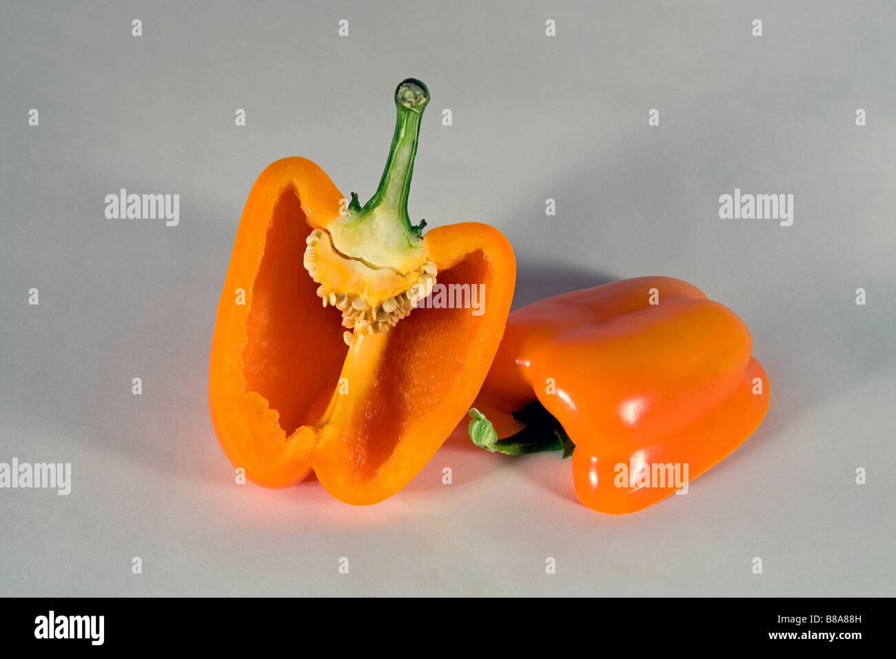 A yellow or orange bell pepper sliced or whole. Stock Photo