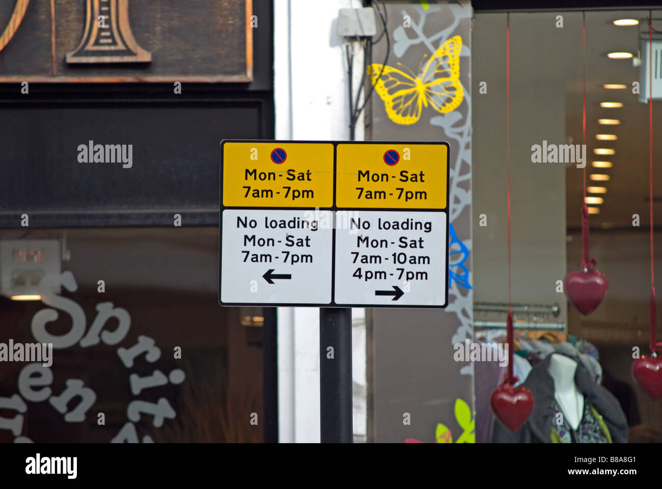 british yellow and white sign showing parking restrictions,  on chiswick high road, west london, england Stock Photo