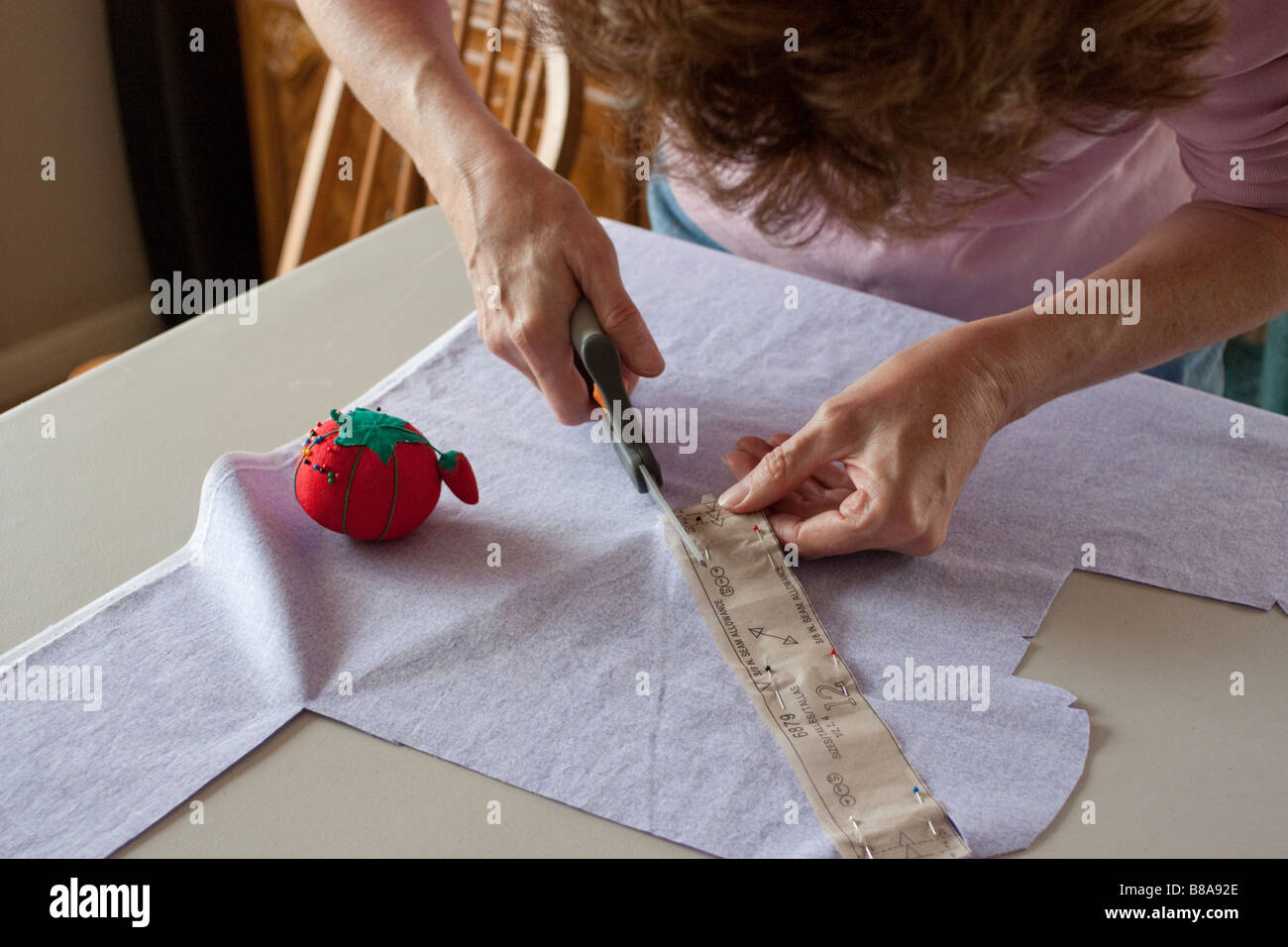 Sewing an outfit for a little girl Stock Photo Alamy
