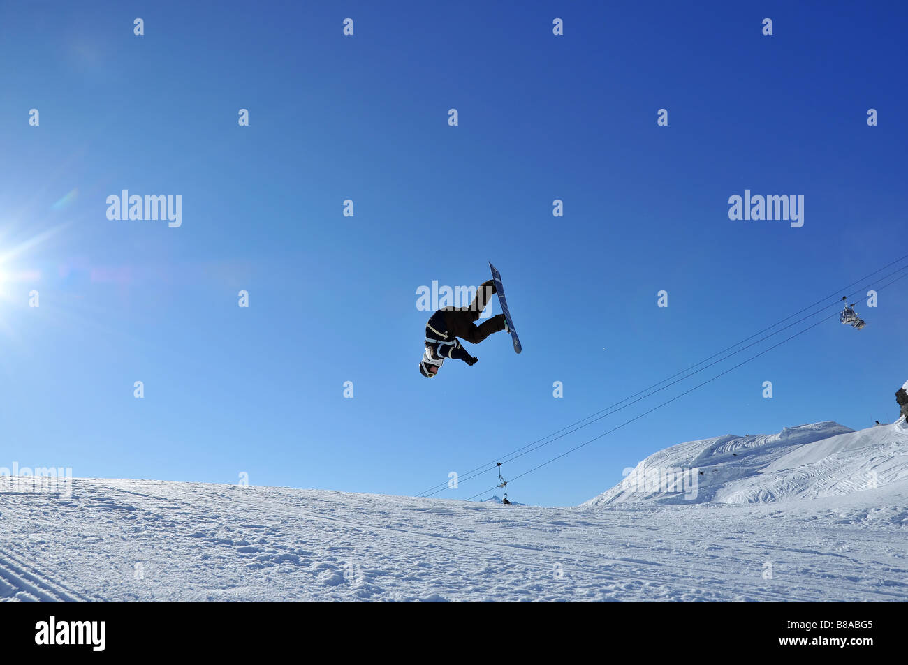 Aeroski A snow boarder performing a summersault Stock Photo