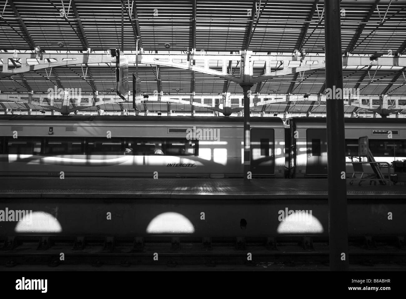 train docked at the railway station, black and white photograph showing play of shadow and light Stock Photo