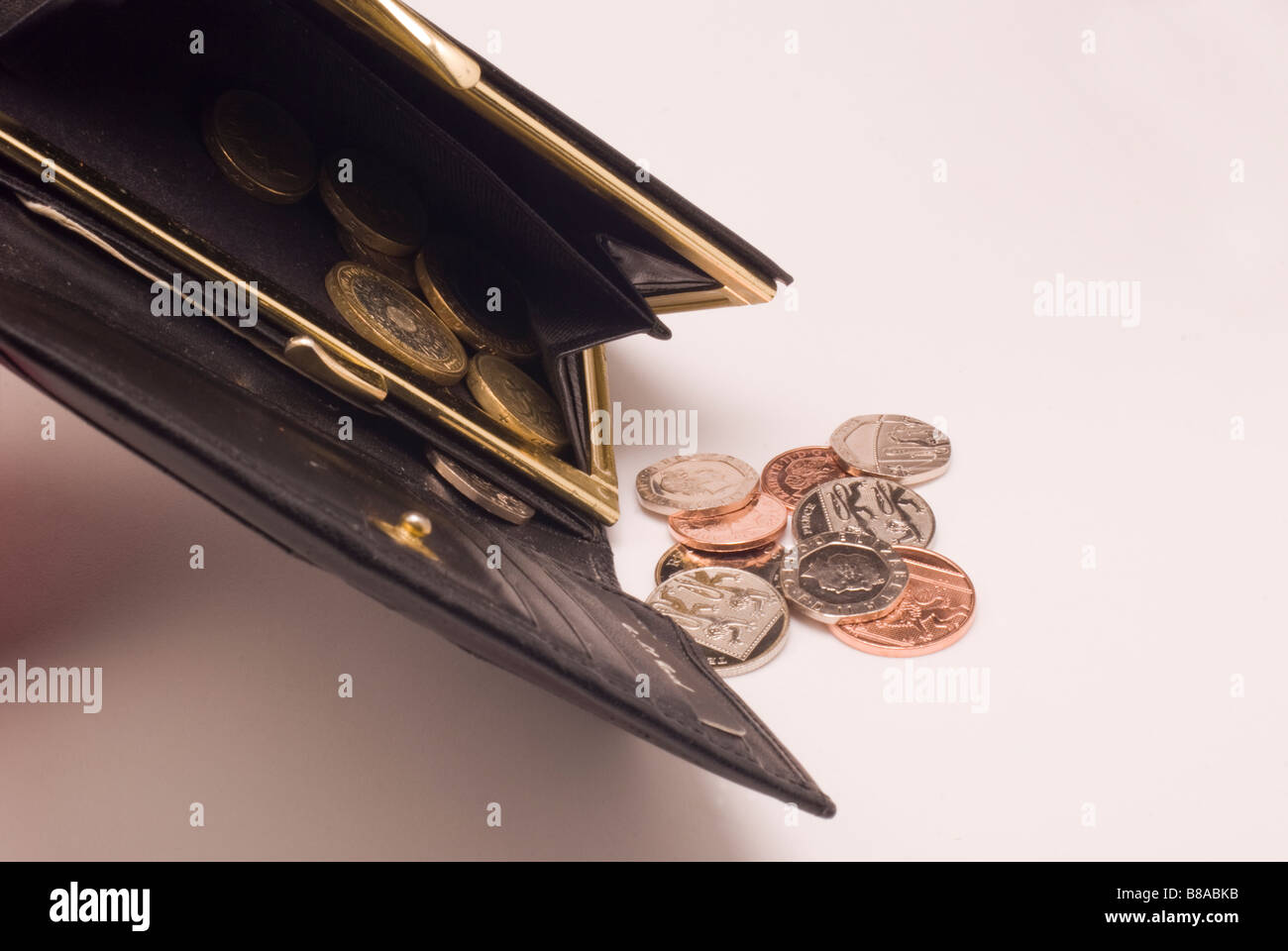 money falling from a purse Stock Photo