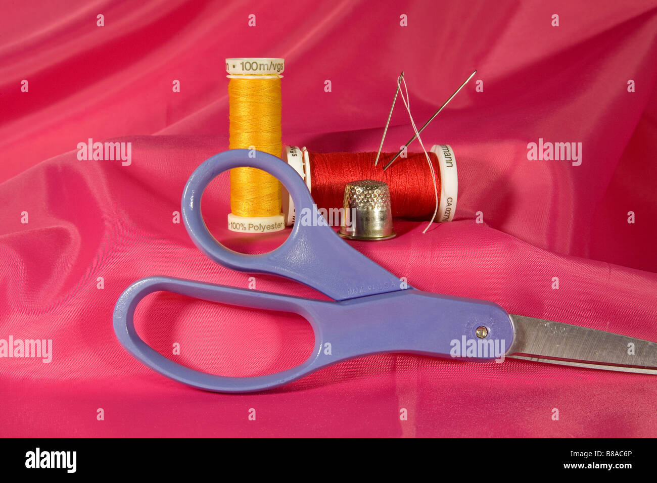 A sewing kit with needle spools of thread a thimble and scissors Stock Photo