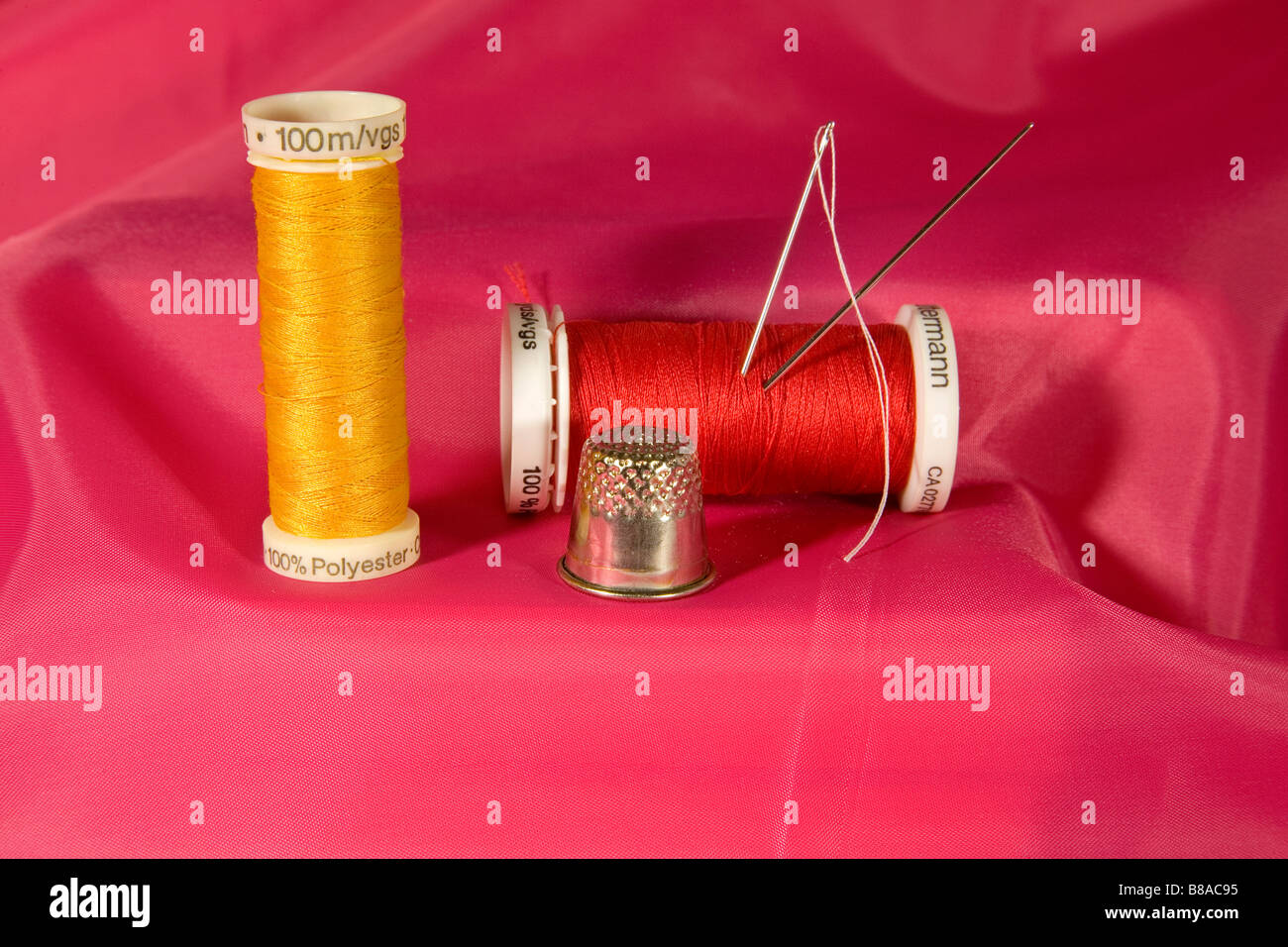 A small sewing kit with spools of thread needles and a thimble Stock Photo