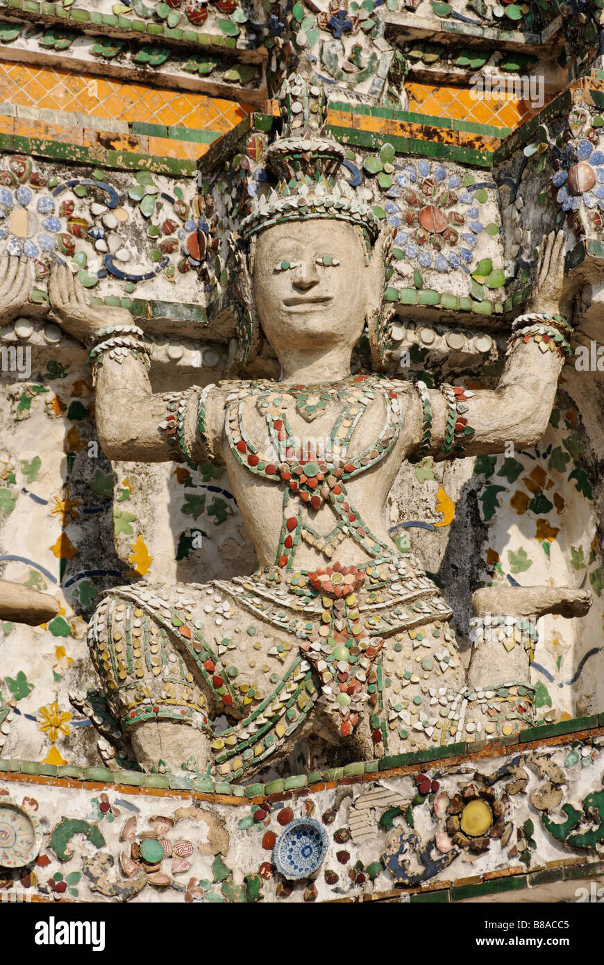 Detail of ceramic tiles and statue Wat Arun buddhist temple in