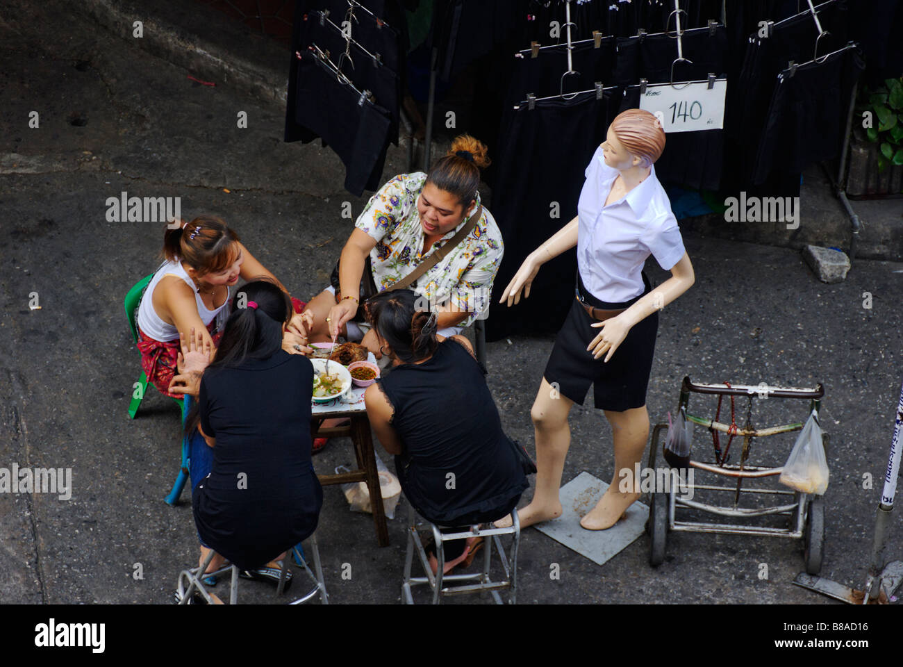 Stall holders having lunch in Banglamphu street market central Bangkok Thailand Stock Photo