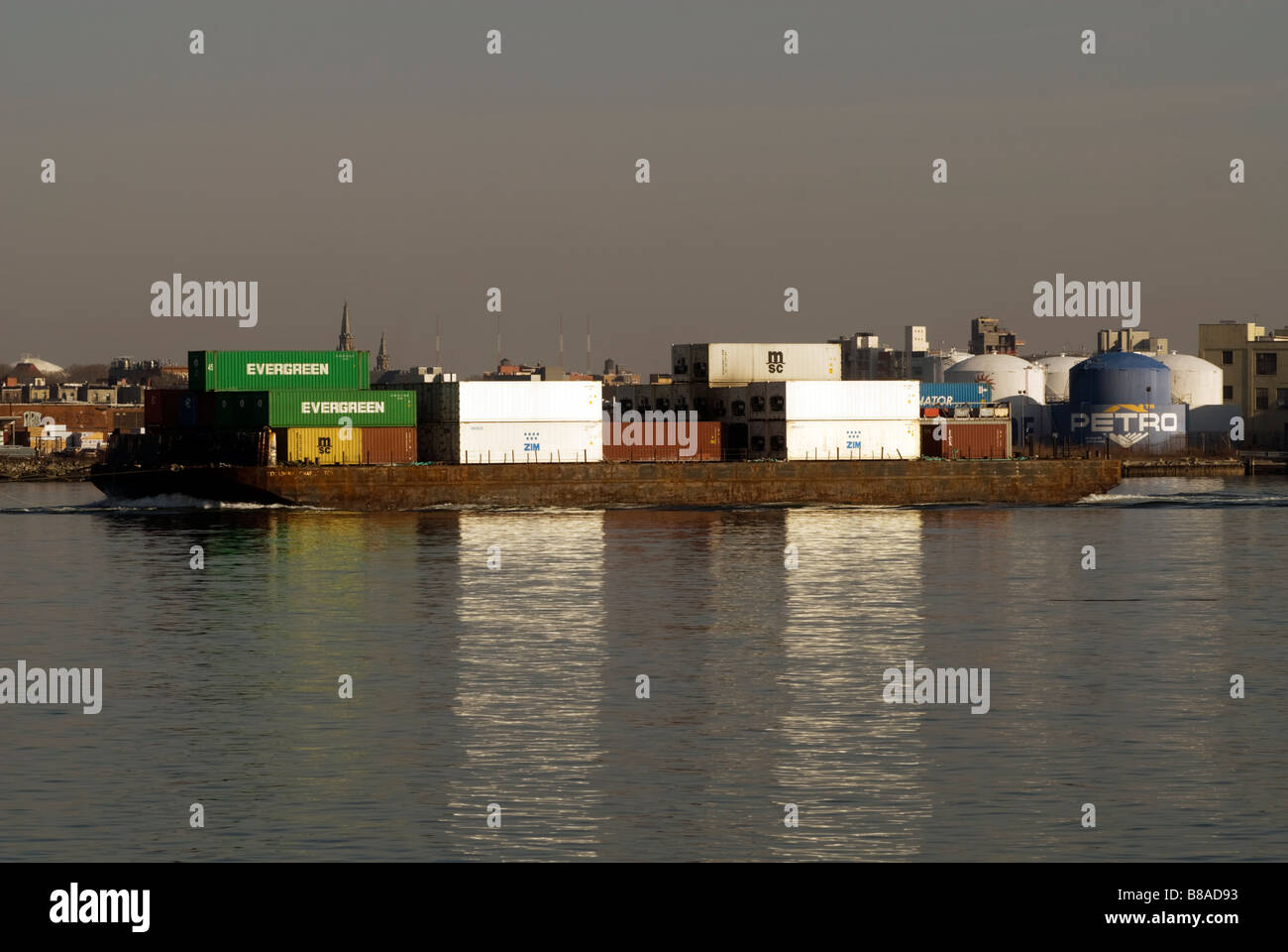 A tugboat tows a barge of containers in the East River in New York on Sunday February 8 2009 Richard B Levine Stock Photo