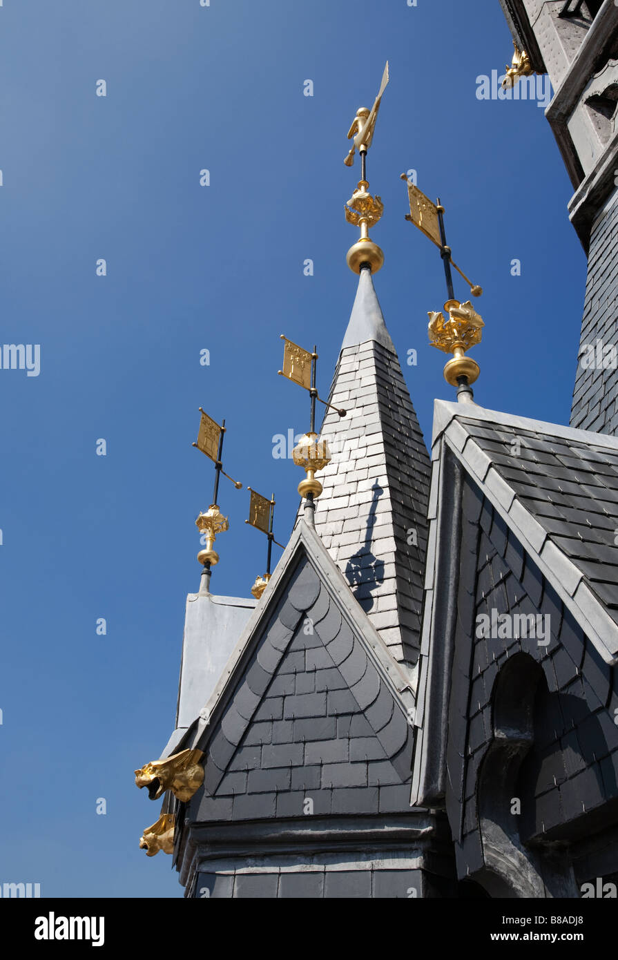 Gold painted metal flag weathervanes and gargoyles on roof of the Belfry tower Tournai Belgium Stock Photo