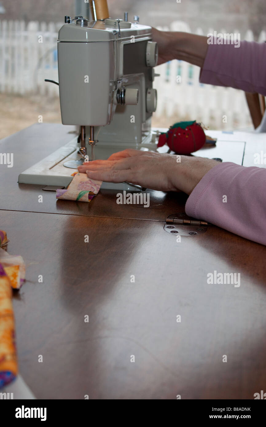 Using the sewing machine Stock Photo Alamy