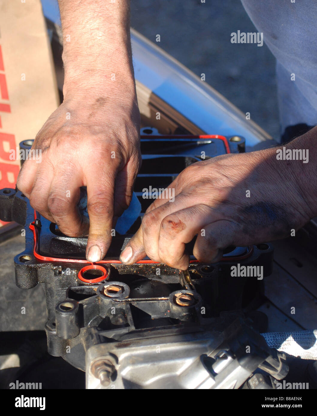 Auto mechanic replacing a plenum gasket on a GM automobile (1995 Buick LeSabre) Stock Photo