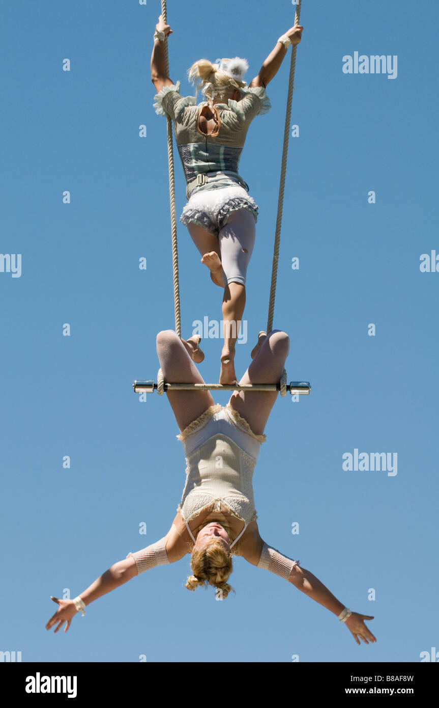 Two female trapeze artists on swing Stock Photo