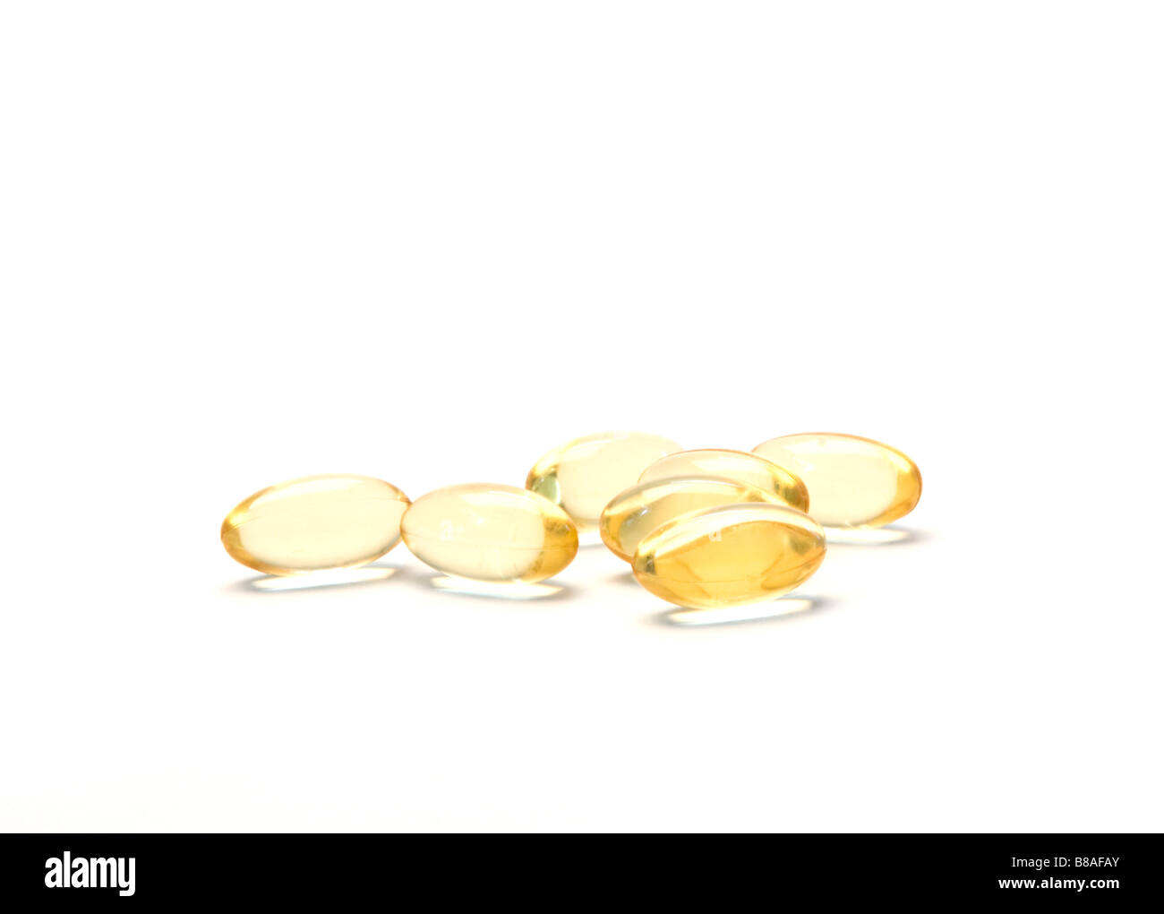 Cod oil capsules are seen in a cutout photo. Stock Photo