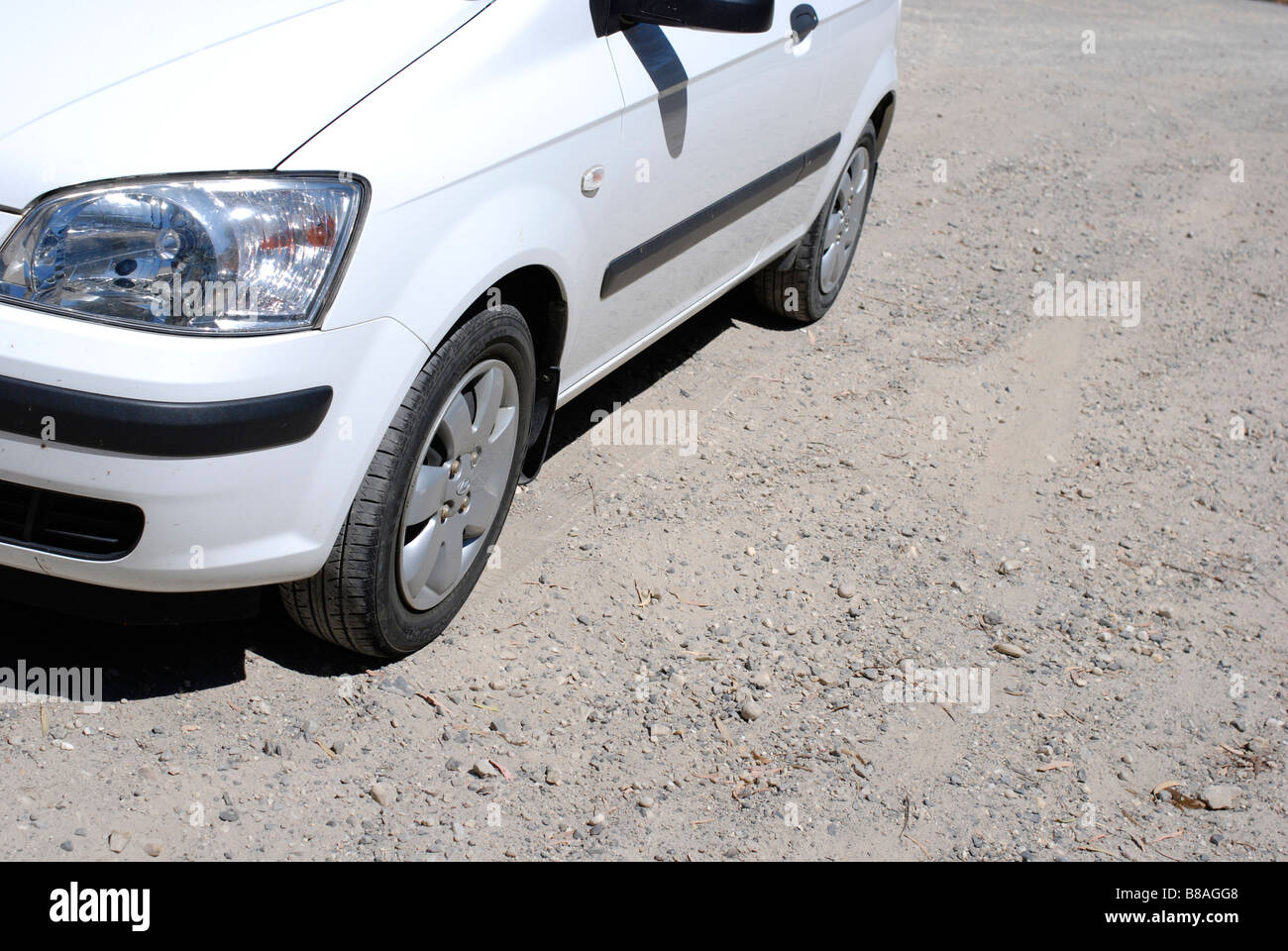 Rental car on unpaved gravel road Stock Photo Alamy
