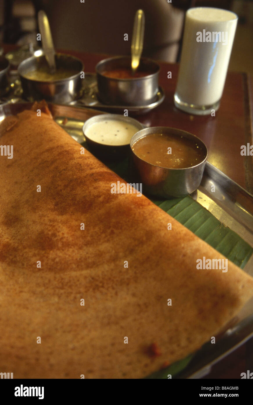 Dosa South Indian speciality a thin crispy crepe filled with vegetable curry served with sambal and chutney Stock Photo