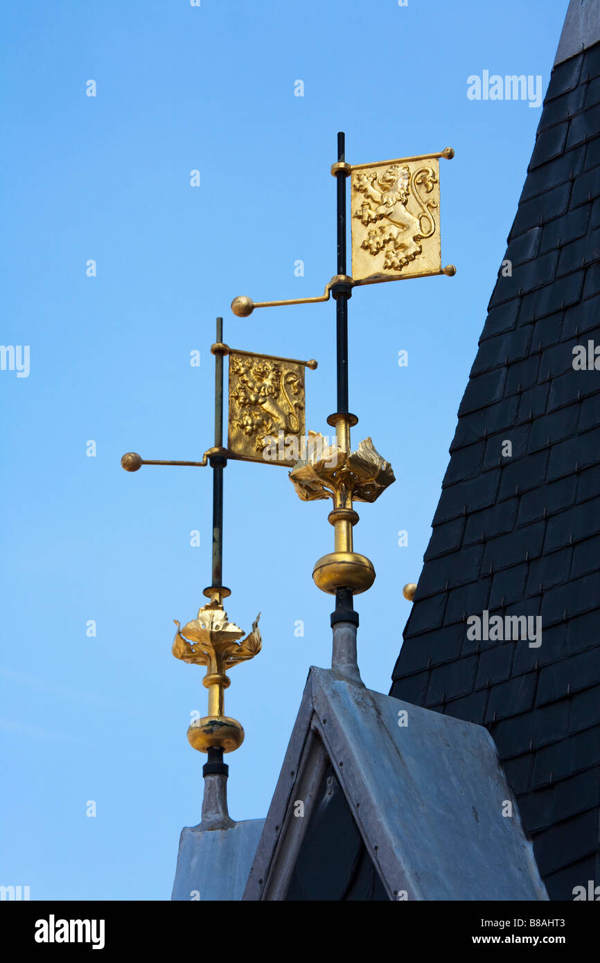 Gold painted standards flags with lion crest on weathervanes on roof of the Belfry tower Tournai Belgium Stock Photo