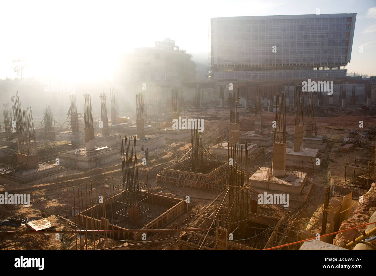 Steel rods poke out of the foundations on a construction site in Bangalore, India. Stock Photo