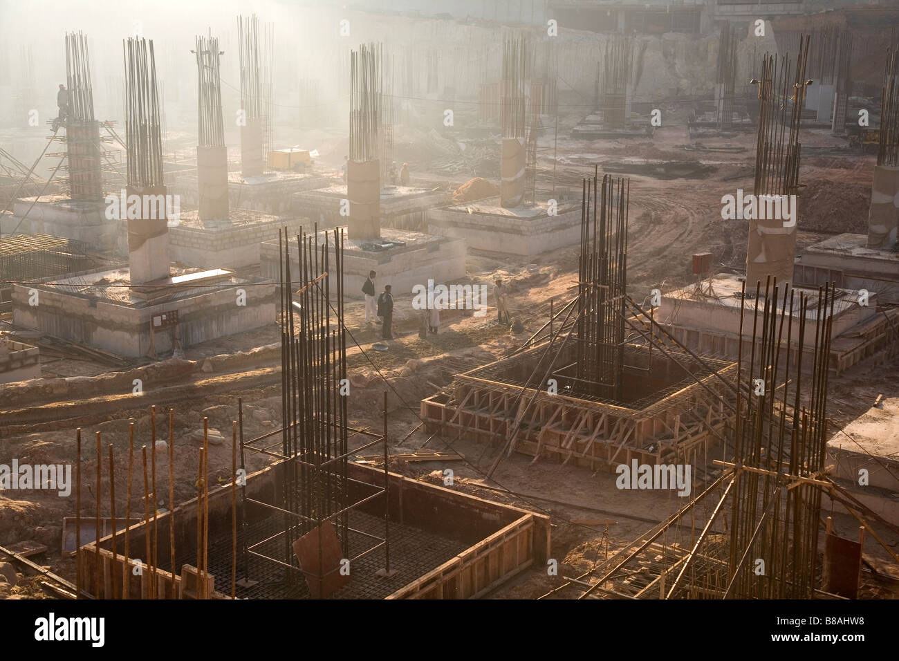 Steel rods poke out of the foundations on a construction site in Bangalore, India. Stock Photo