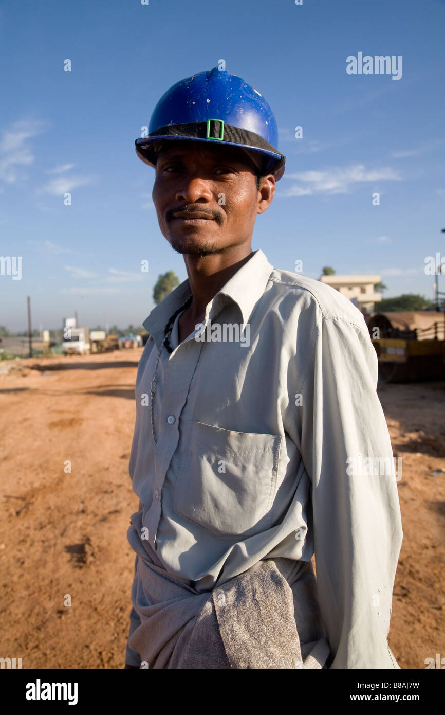 A Worker Wears A Safety Helmet On A Construction Site In Bangalore