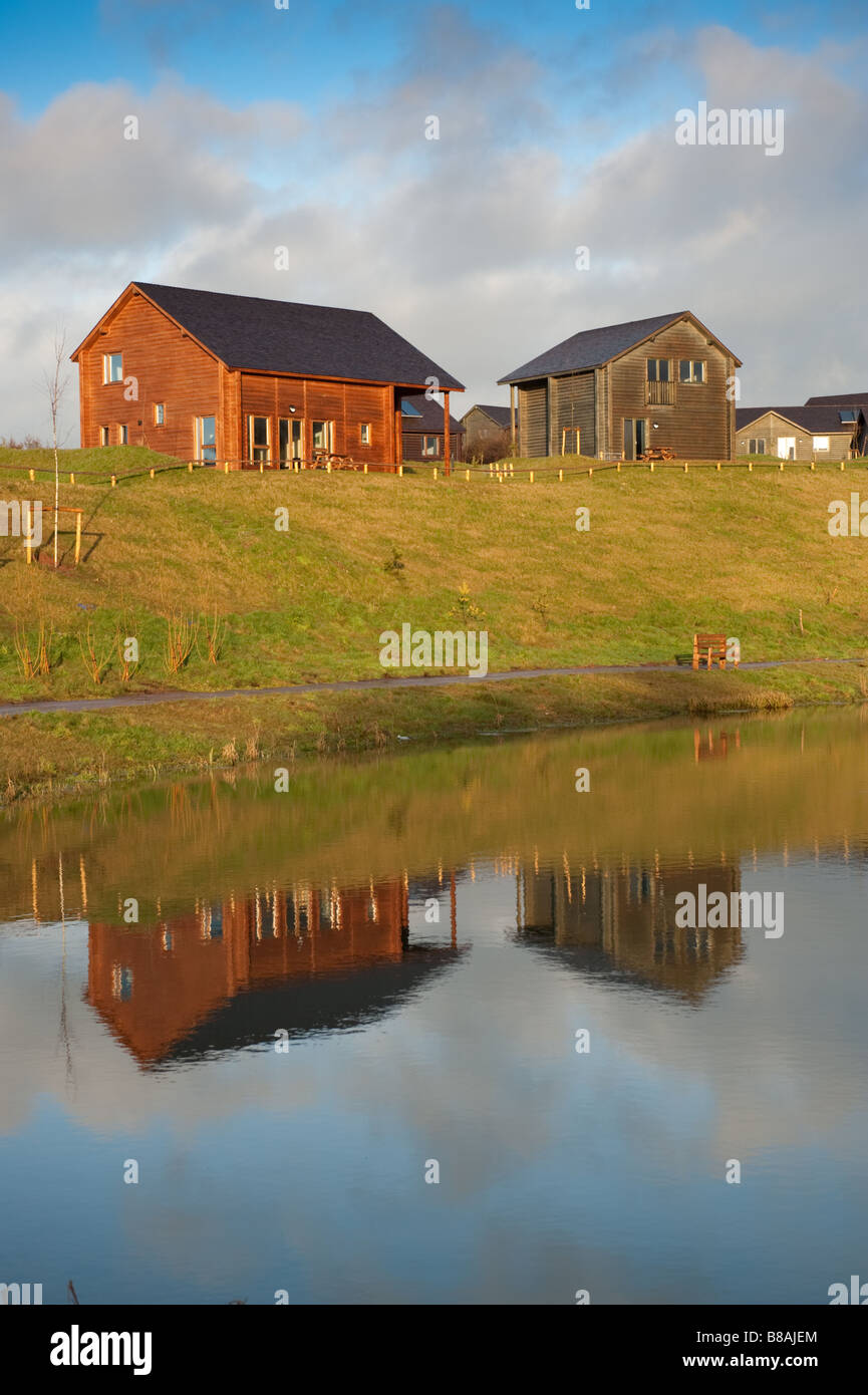 wooden cabins around the lake at Bluestone holiday park Pembrokeshire