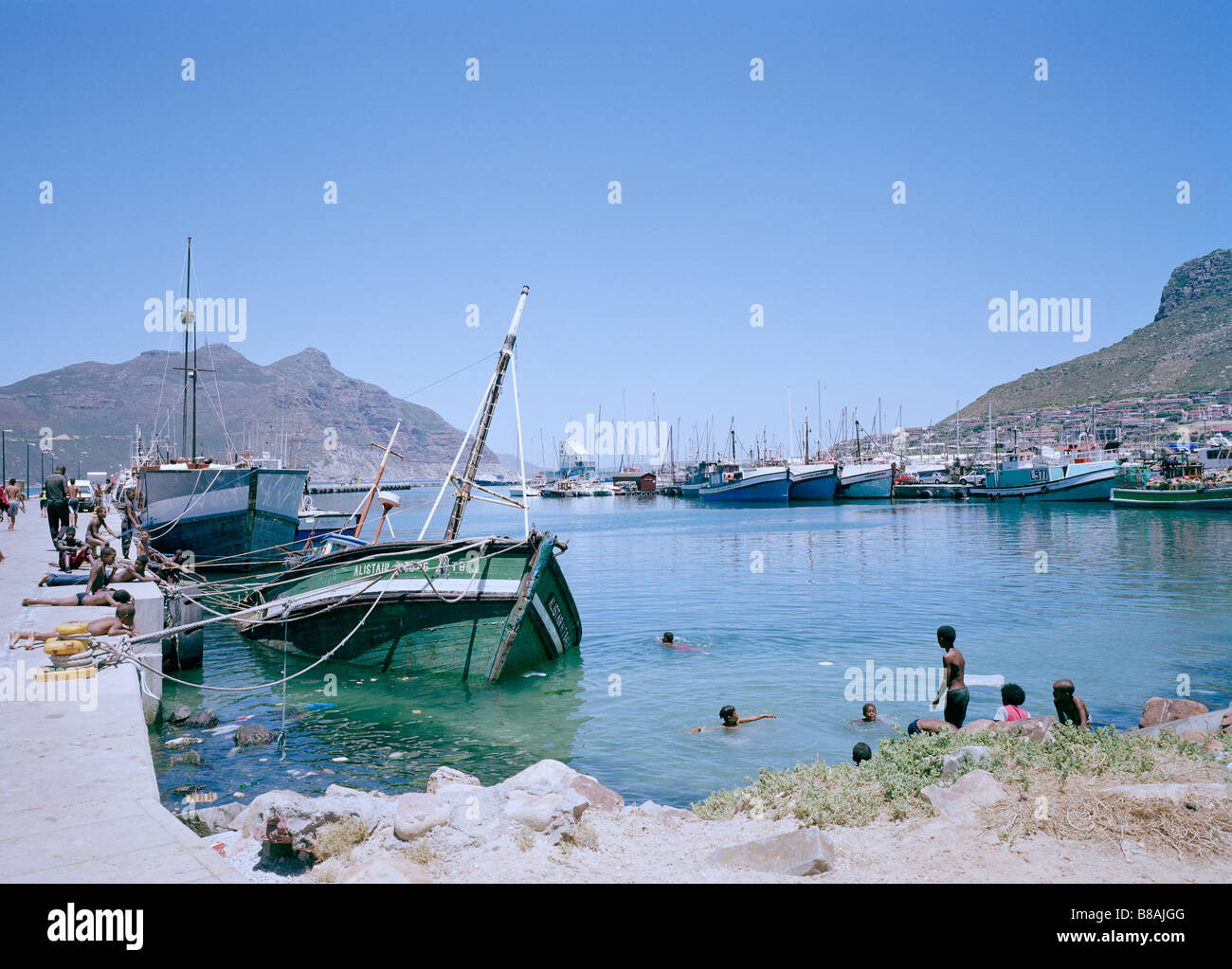 Fishing trawlers in Mariner's Wharf in Hout Bay in Cape Town in South Africa in Sub Saharan Africa. Resort Harbour Holiday Vacation Sea People Travel Stock Photo