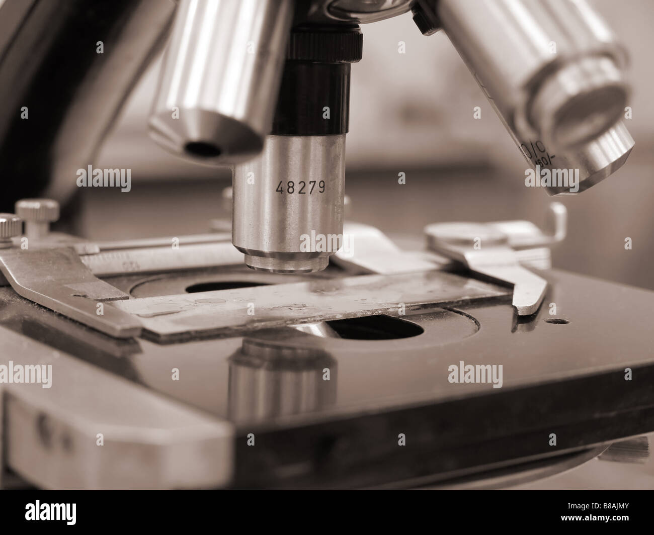 Closeup shot of old microscope revolving nosepiece with specimen Stock Photo