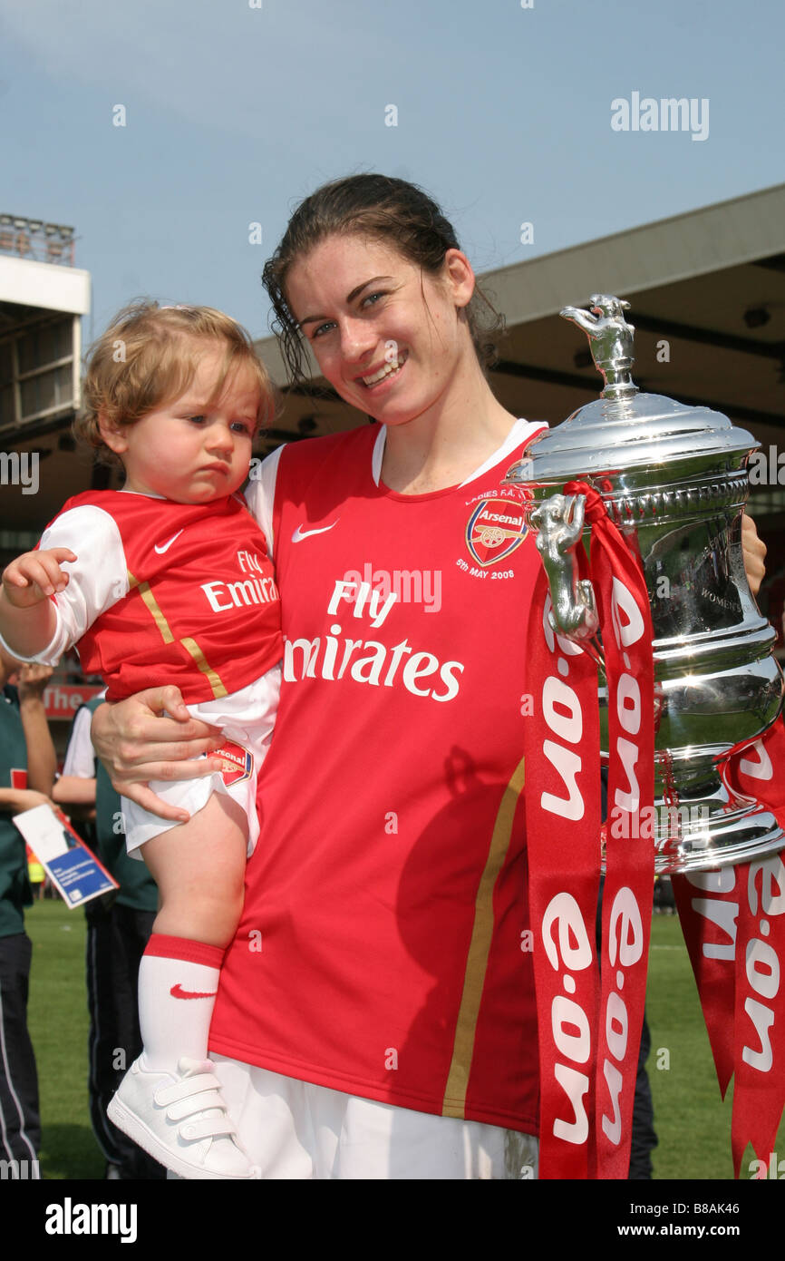 Karen Carney Arsenal  Ladies FC holding niece and cup after 