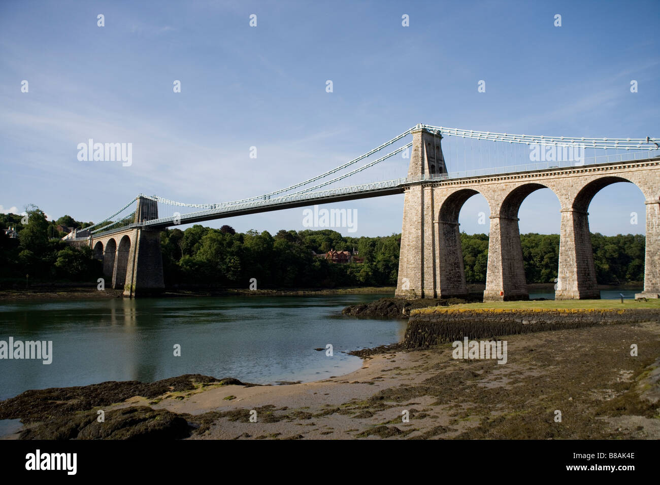 The Suspension Bridge and Menai Straits from Menai Bridge town on Anglesey , Gwynedd, North Wales Stock Photo