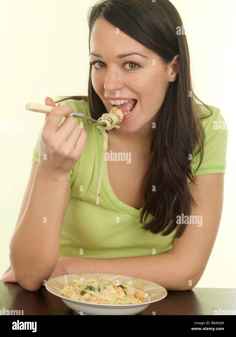 Healthy Happy Young Woman Eating Italian Style Prawn Linguine Meal Alone Wi...