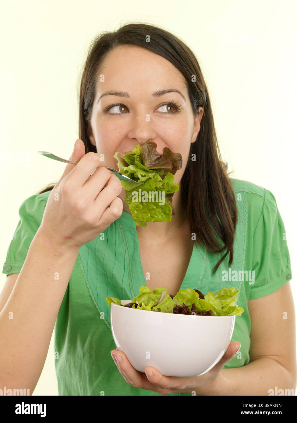 Young Woman Eating Freshly Prepared Healthy Green Salad With A Clipping