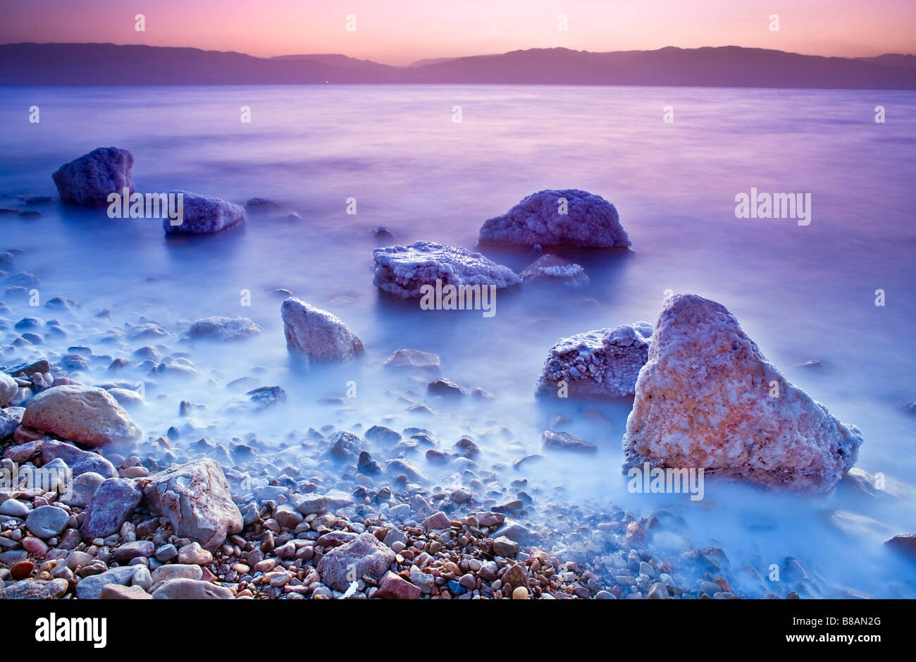 sunrise over the dead sea with waves in motion blur Stock Photo