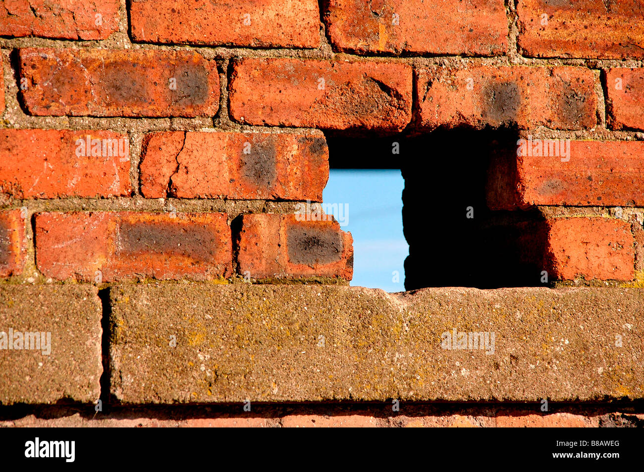 A hole in a brick wall. Stock Photo