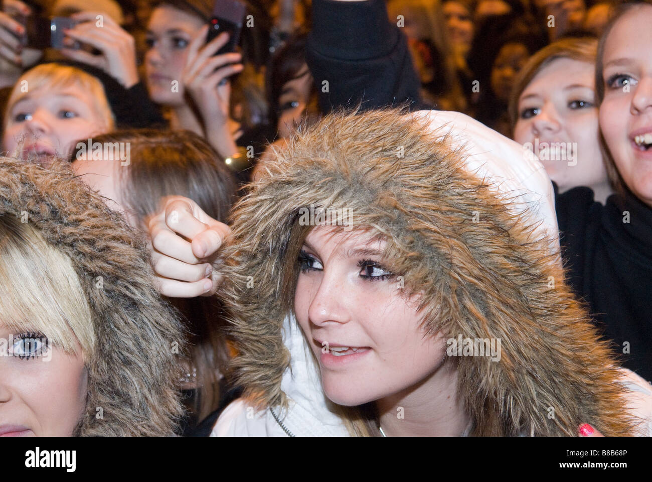 crowd of young people gathered to see reality TV stars watching