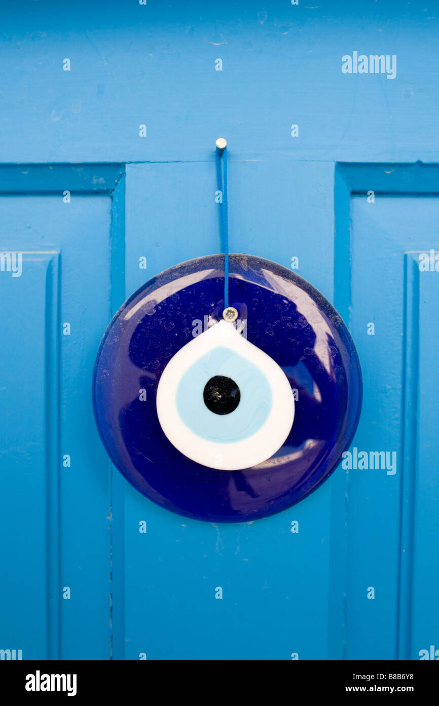 Close-up shot of a blue eye (nazar) amulet, used to fence off evil, hung at  the entrance door from a typical local Greek house Stock Photo - Alamy