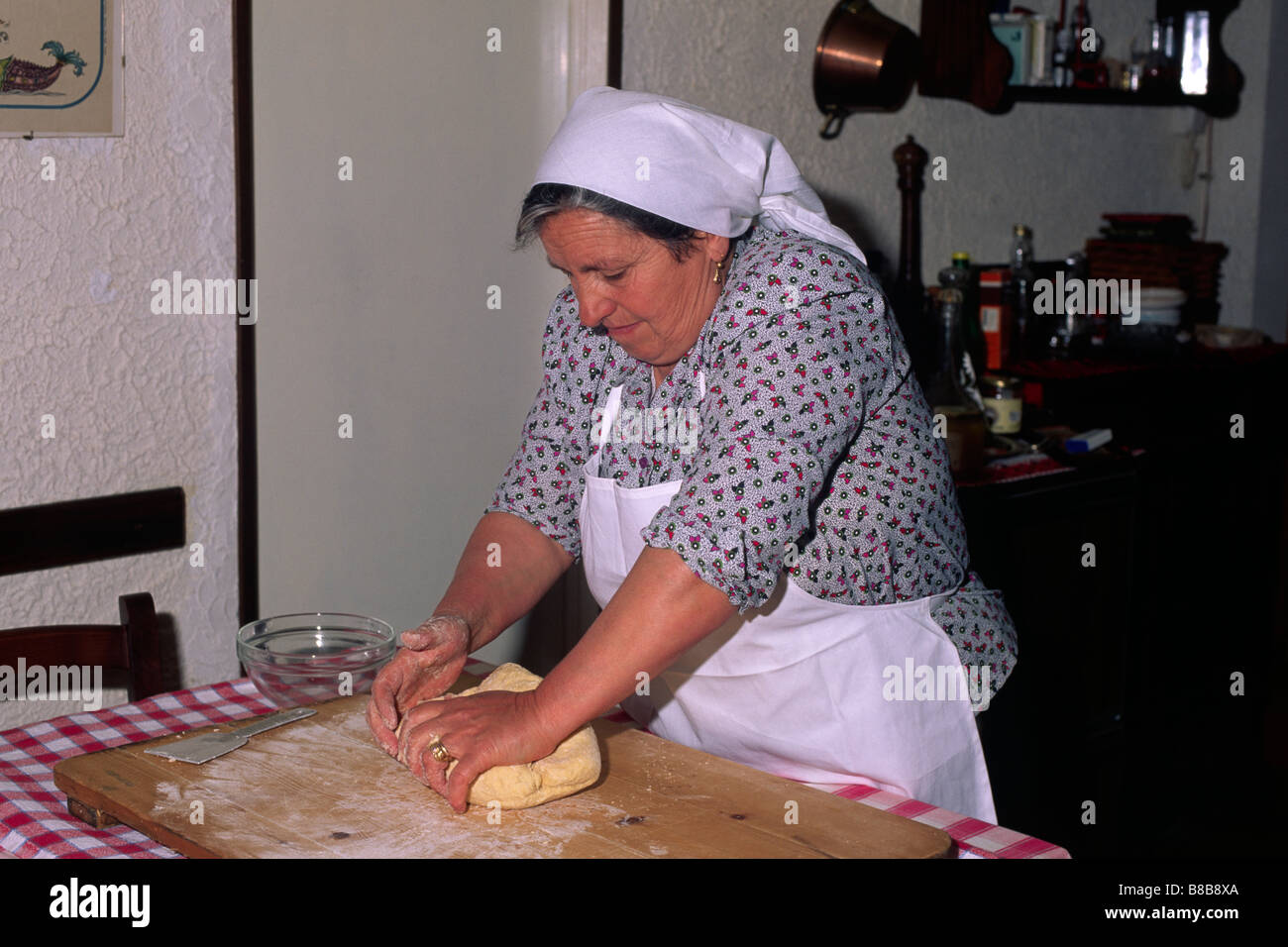 Italy, Calabria, woman preparing traditional pasta with flour and eggs Stock Photo