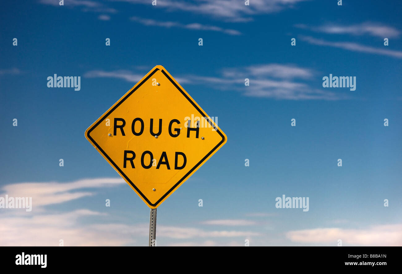 A sign that indicates a rough road ahead Stock Photo