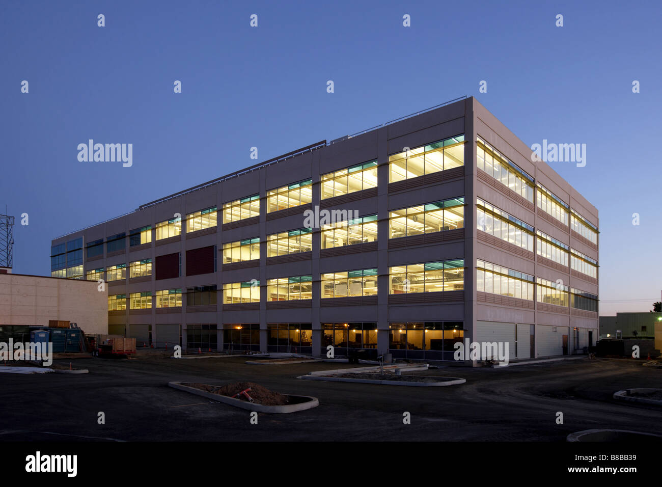 An office building with a empty parking lot Stock Photo