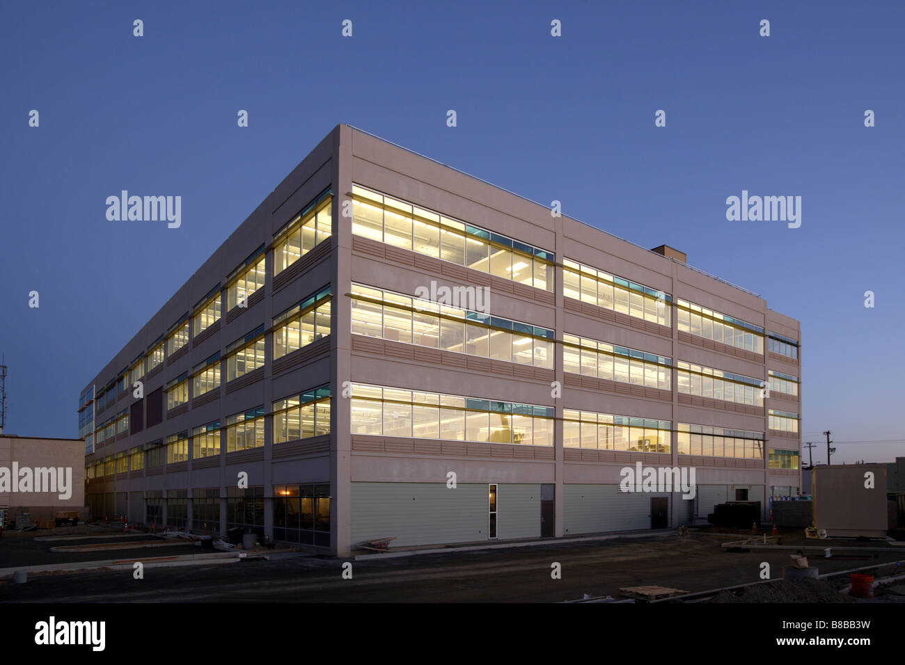 An office building with a empty parking lot Stock Photo