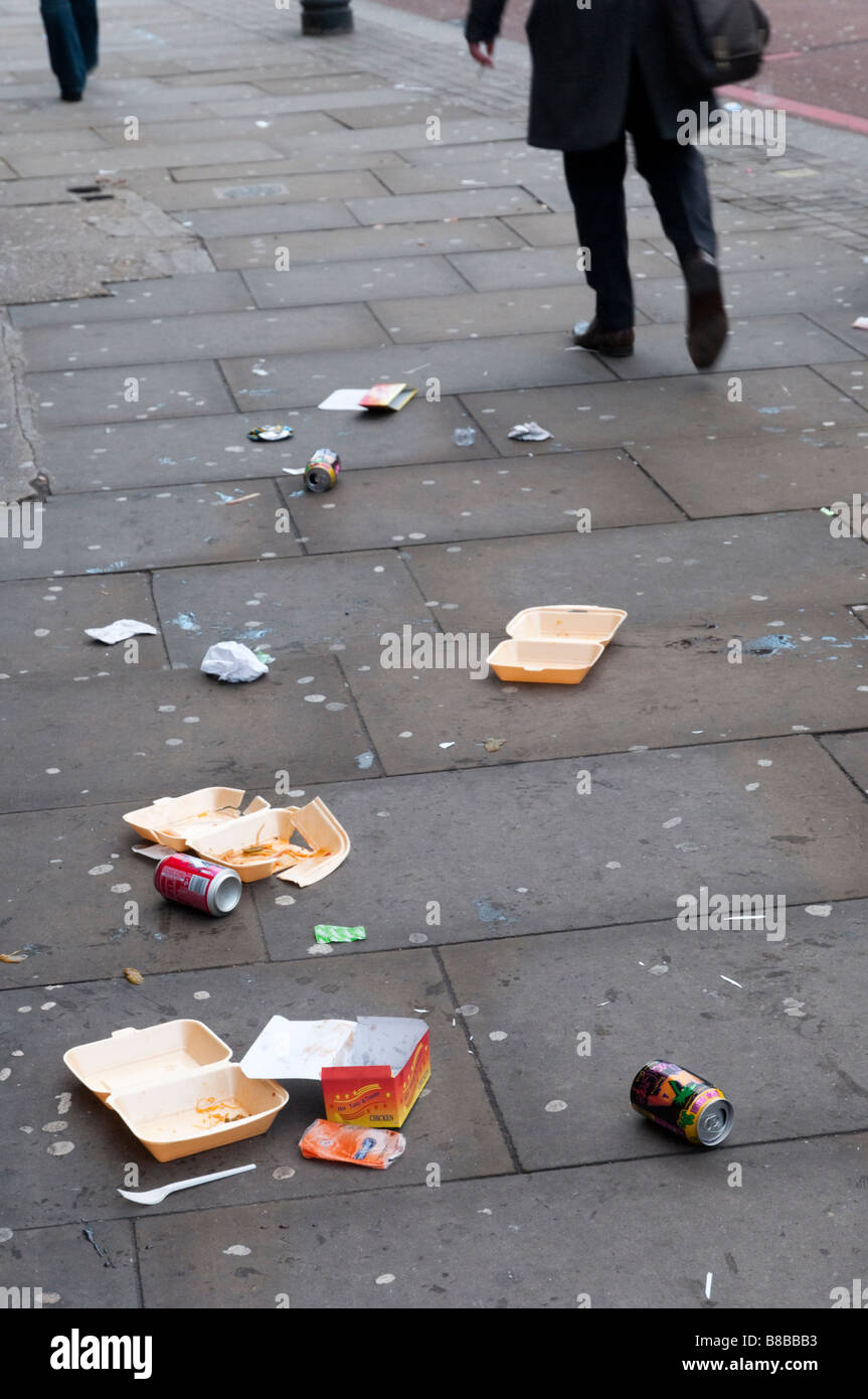 People walking past litter on the pavement, England UK Stock Photo