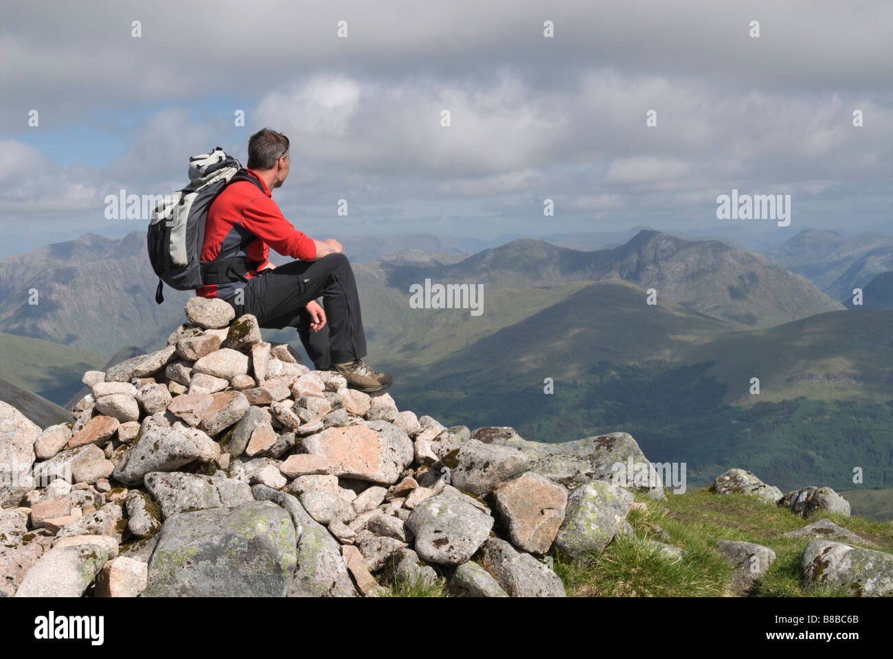 HILL WALKER ON THE SUMMIT OF SGORR DHONUILL MUNRO LOOKING TOWARDS SGOR NA H ULAIDH MUNRO GLEN