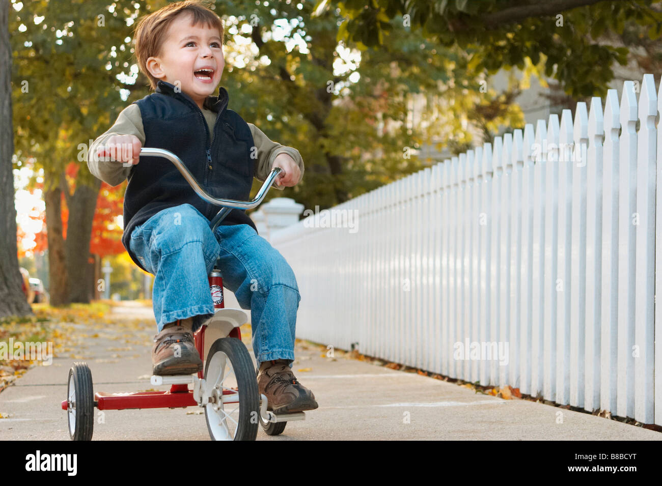 Little Boy Riding Tricycle Autumn, Brampton,Ontario Stock Photo