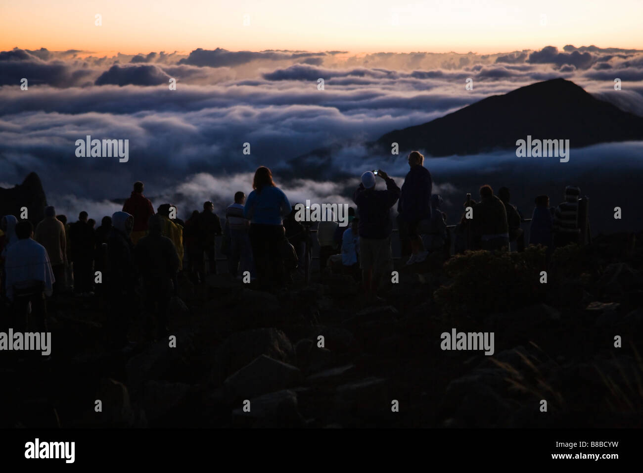 A large group of people watching the sun rise atop Haleakala Volcano on Maui Hawaii September 2008 Stock Photo