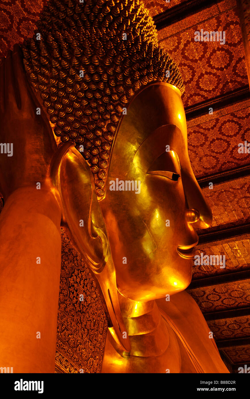 Face of reclining golden buddha statue in Wat Pho temple Phra Nakorn district in central Bangkok Thailand Stock Photo