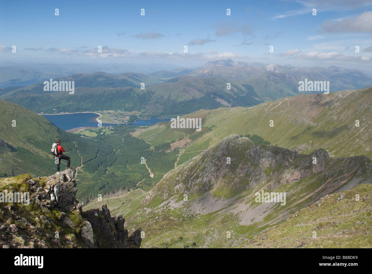 HILL WALKER NEAR THE SUMMIT OF SGORR DHONUILL MUNRO LOOKING TOWARDS BALLACHULISH LOCH LEVEN AND