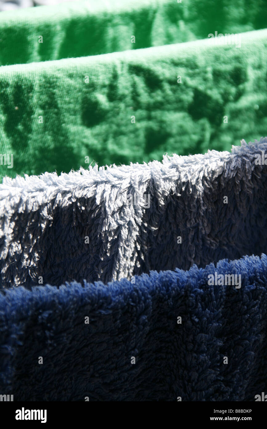 many wet towels hanging on washing line in sun Stock Photo